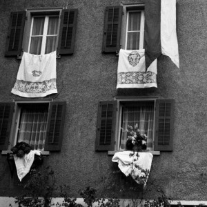 Facade with a festive flag. Canton of Graubünden, Switzerland 1970.